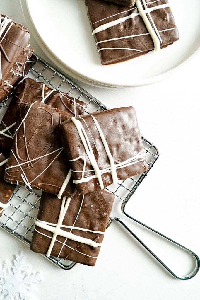 overhead view of chocolate covered graham crackers with white chocolate design 