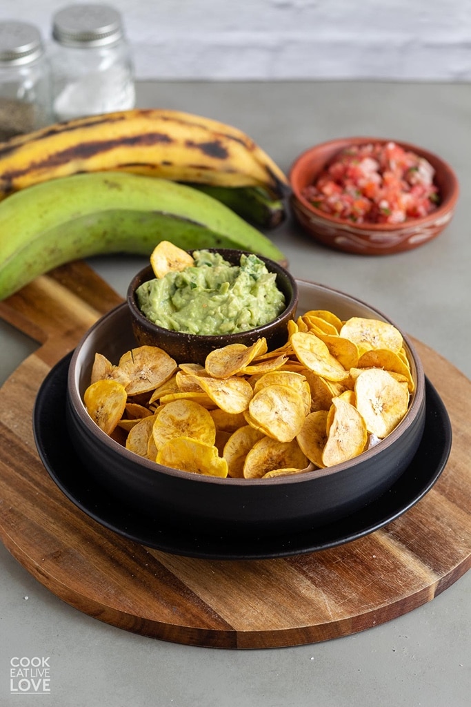 plantain chips in serving dish with guacamole on side 
