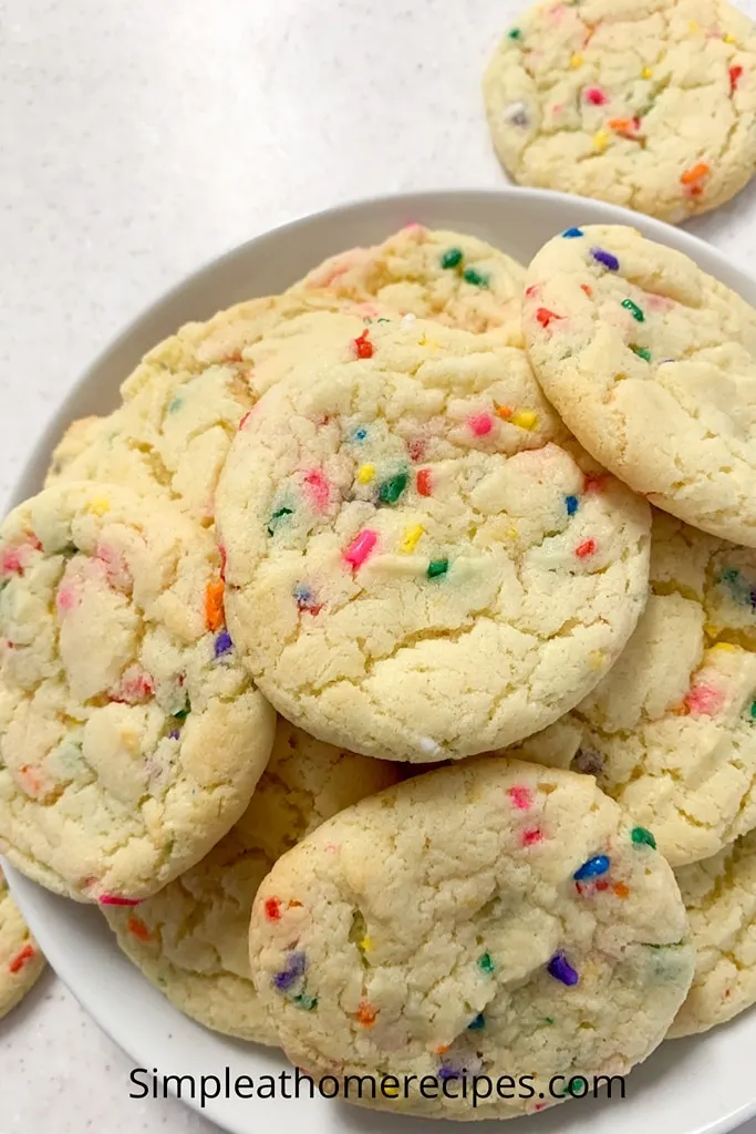 rainbow sprinkle cake mix cookies on white plate 