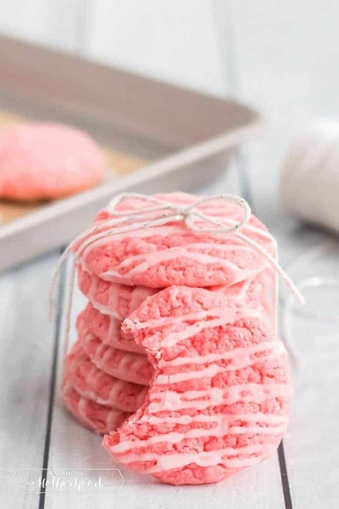 50 Easy Christmas Cookie Recipes with 7 Ingredients or Less 51 stack of strawberry cake mix cookies with pink icing on top