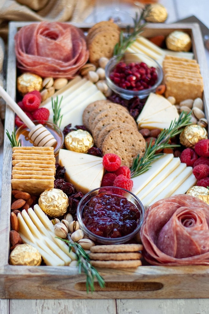35 Party Appetizers For New Years Eve 12 huge charcuterie board with crackers, jam, cheese and meat flowers