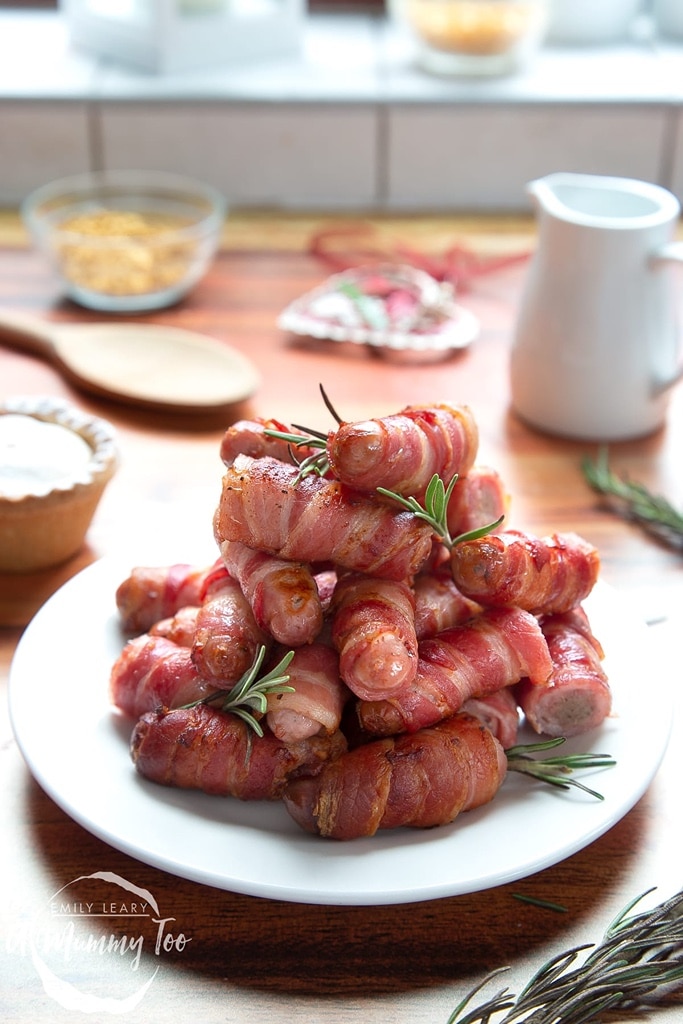 35 Party Appetizers For New Years Eve 13 stack bacon wrapped sausages on top of white plate