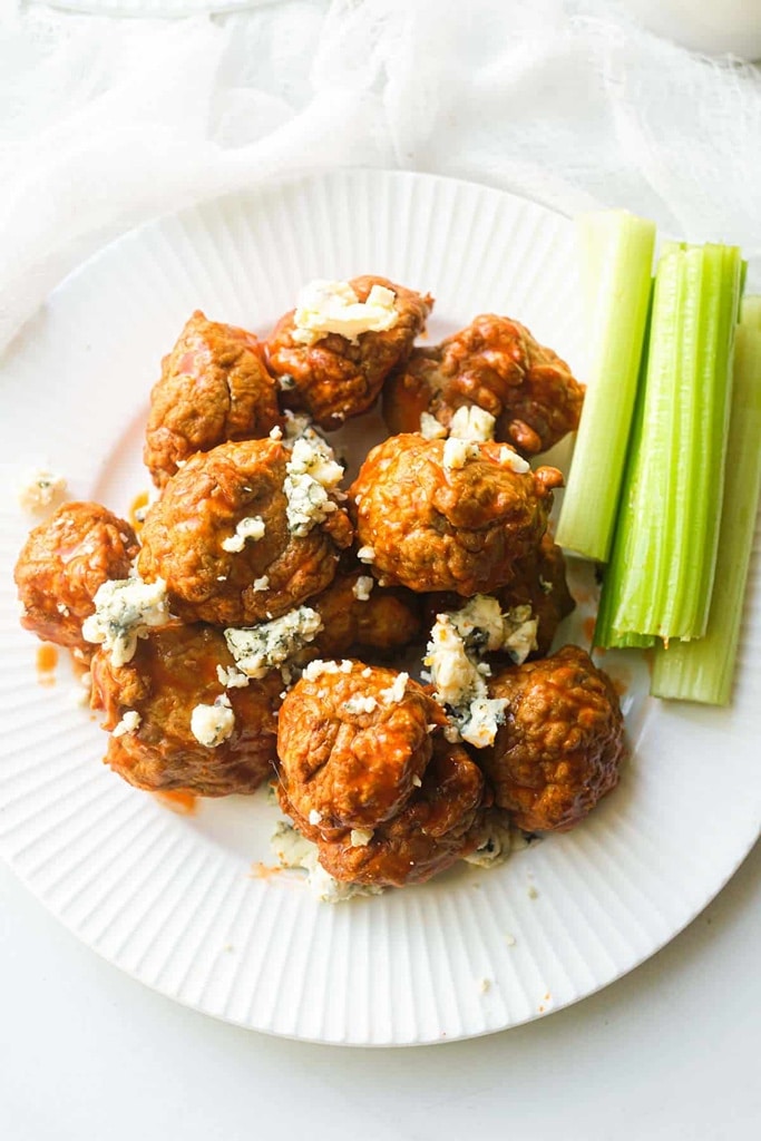 35 Party Appetizers For New Years Eve 14 chicken meatballs covered in buffalo sauce and blue cheese crumbles with celery on the side