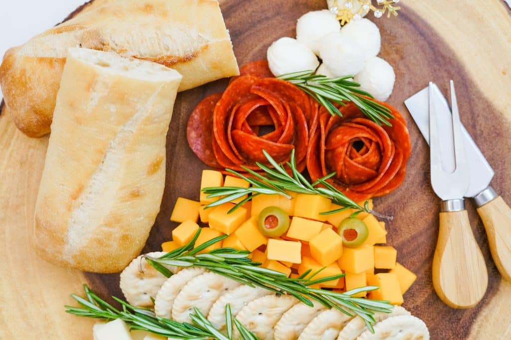 Easy Christmas Tree Charcuterie Board 8 close up of meats, cheeses, rosemary and bread in Christmas tree shape