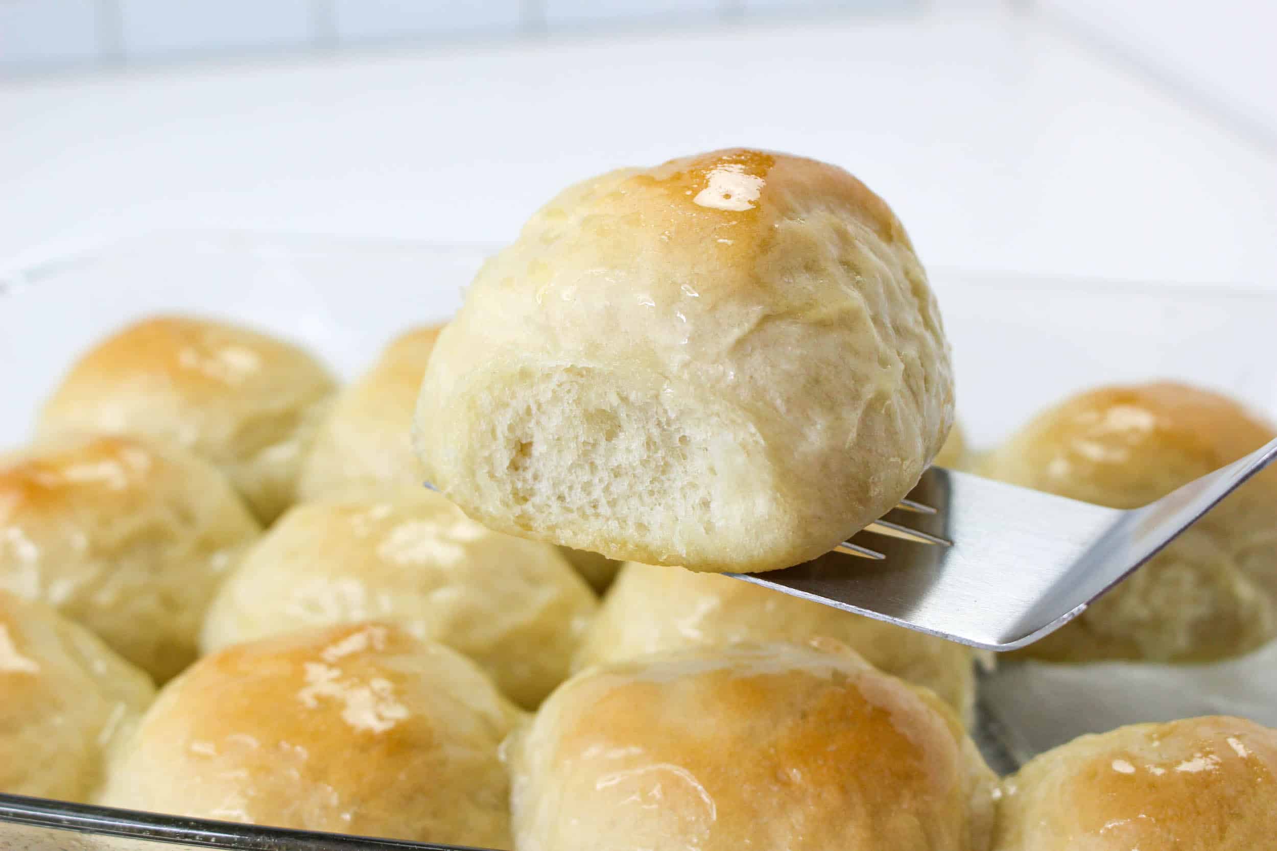 buttered dinner roll in glass pan 