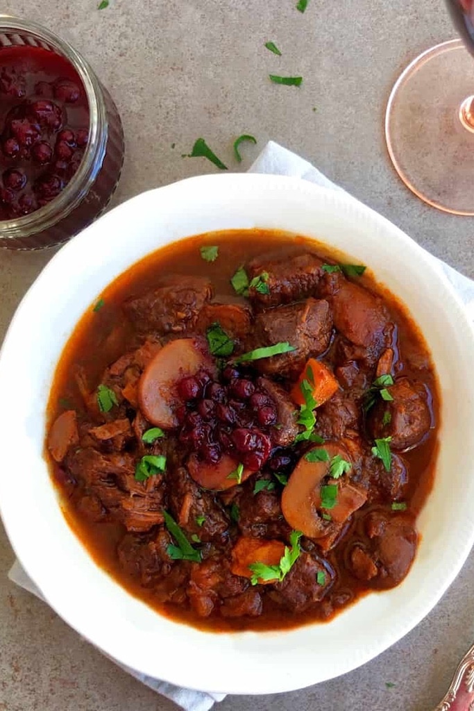 25 Venison Recipes You Will Love 2 German venison goulash with cilantro on top in white bowl