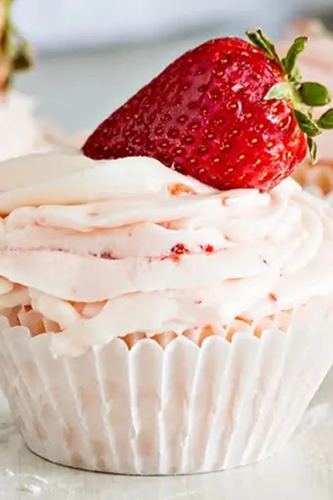 strawberries and cream cupcake with strawberries on top 