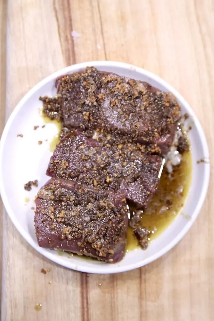 deer meat venison steak on white plate 