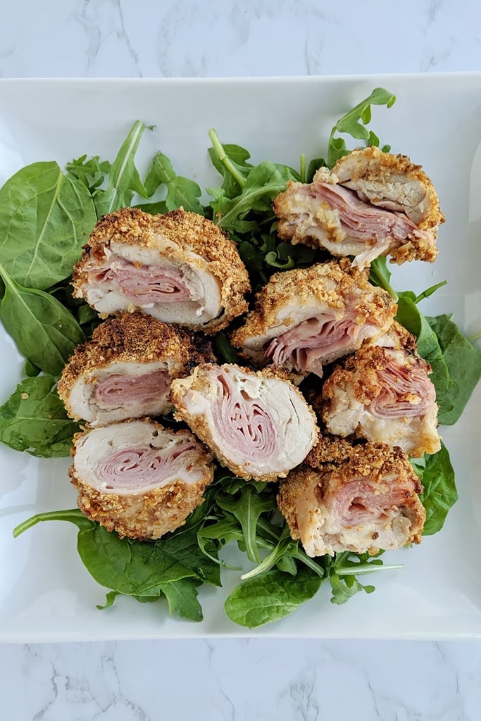 air dryer cordon bleu chicken thighs on bed of greens on white plate 