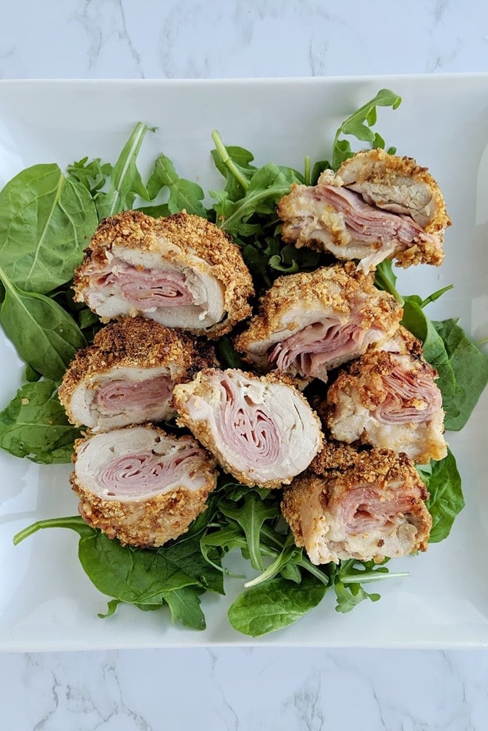 25 Boneless Skinless Chicken Thighs Recipes 19 air dryer cordon bleu chicken thighs on bed of greens on white plate
