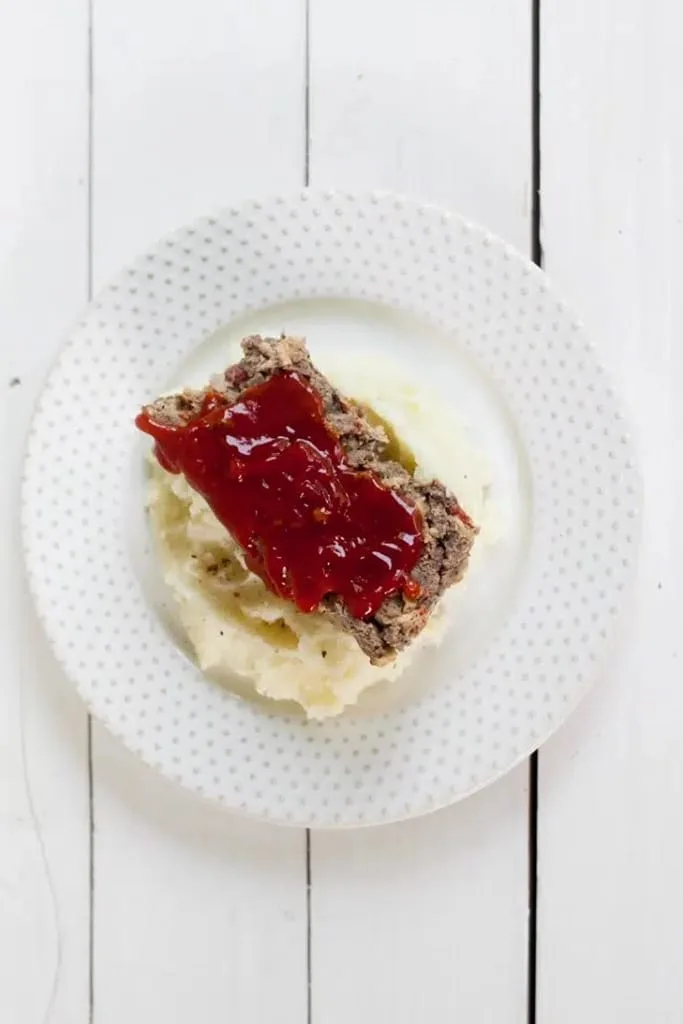 25 Venison Recipes You Will Love 20 deer meat venison meatloaf on top of mashed potatoes on white plate
