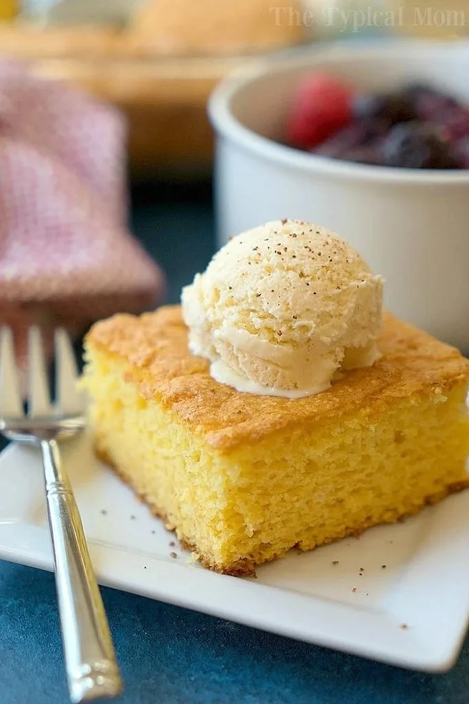 slice of eggnog pudding cake with scoop of icing on top 