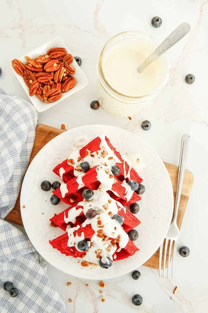 25 Valentine’s Day Breakfast Ideas For Kids 3 red velvet waffles with white chocolate drizzle and blueberries