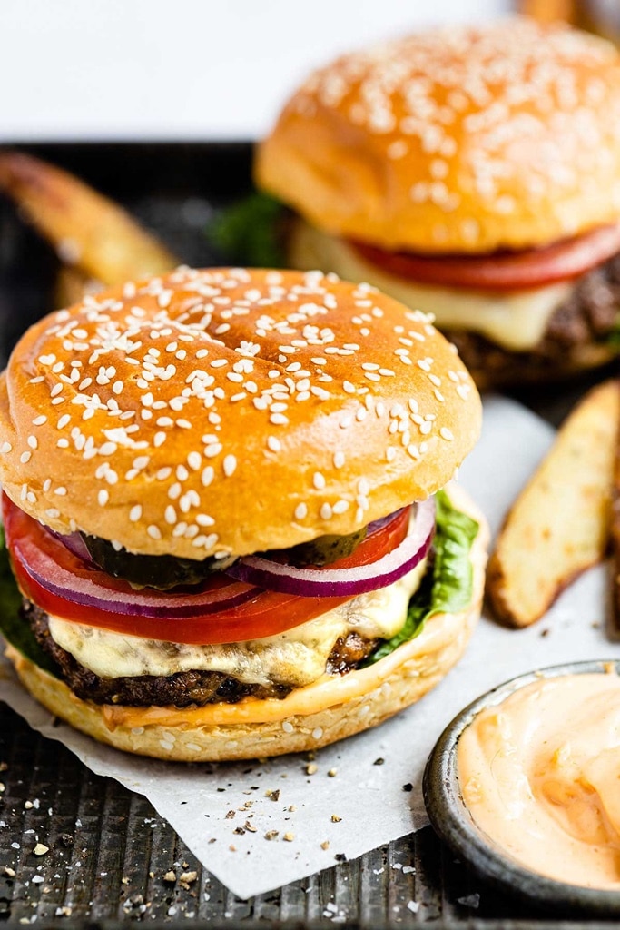 25 Venison Recipes You Will Love 24 close up of deer meat venison burgers with potato wedges on the side