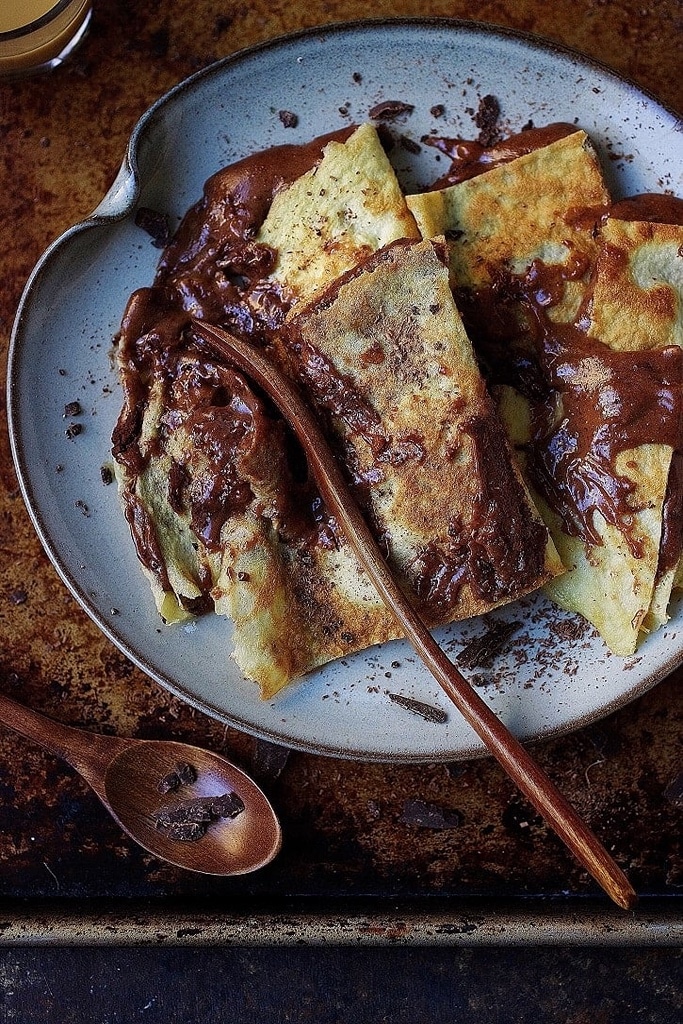 chocolate almond crepes with chocolate drizzled on top 