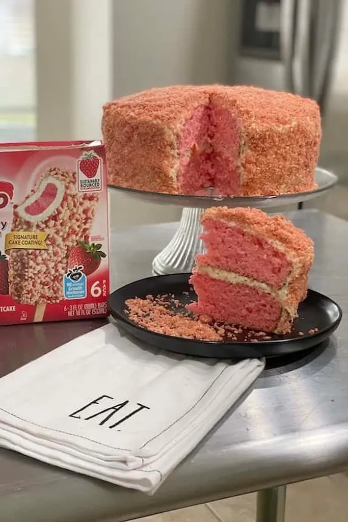 slice of strawberry shortcake cake on black plate 