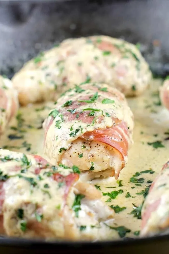 close up of chicken thigh wrapped in prosciutto 