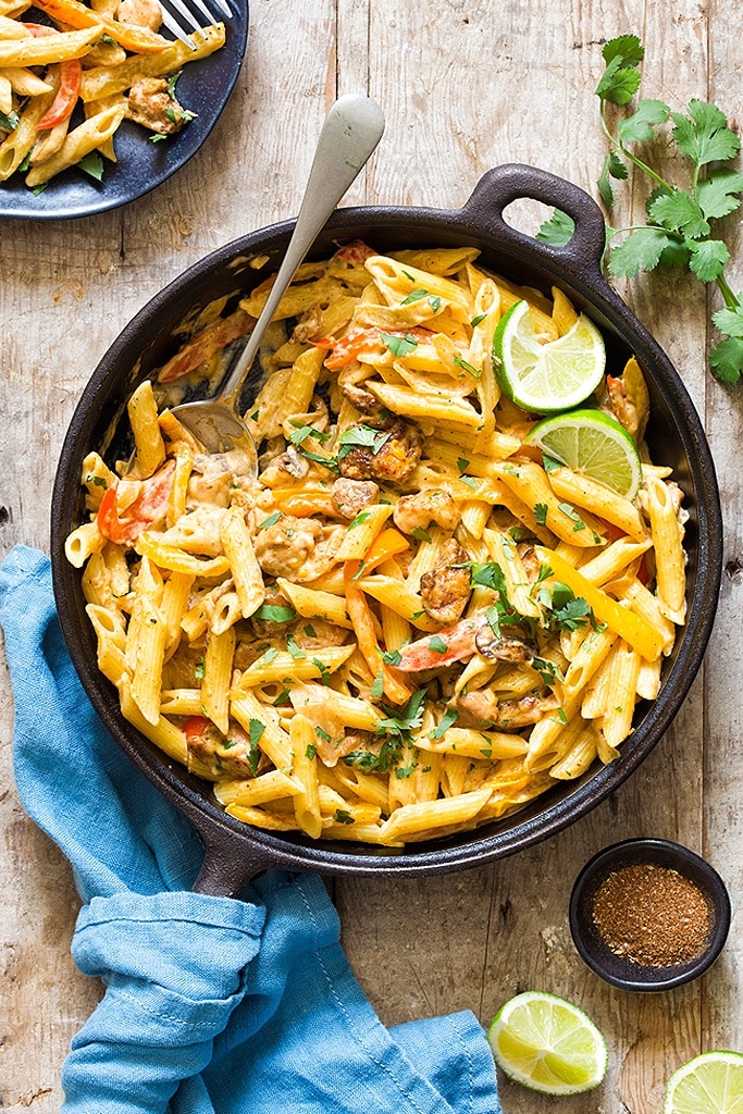 25 Boneless Skinless Chicken Thighs Recipes 8 fajita feta chicken thighs with pasta in cast iron pot with lime on side