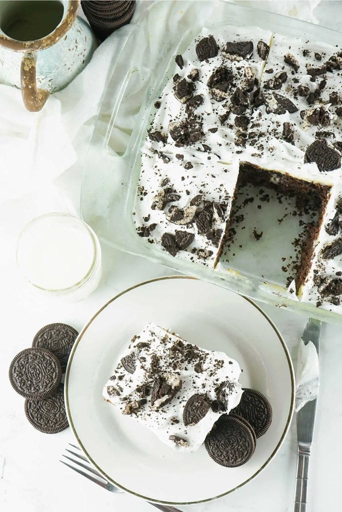25 Box Cake Mix With Pudding Recipes 10 oreo poke cheesecake in glass casserole dish with slice on white plate