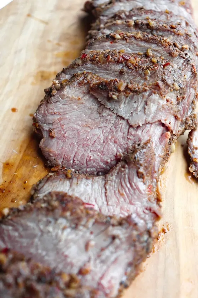 wooden platter of sliced sous vide backstrap 