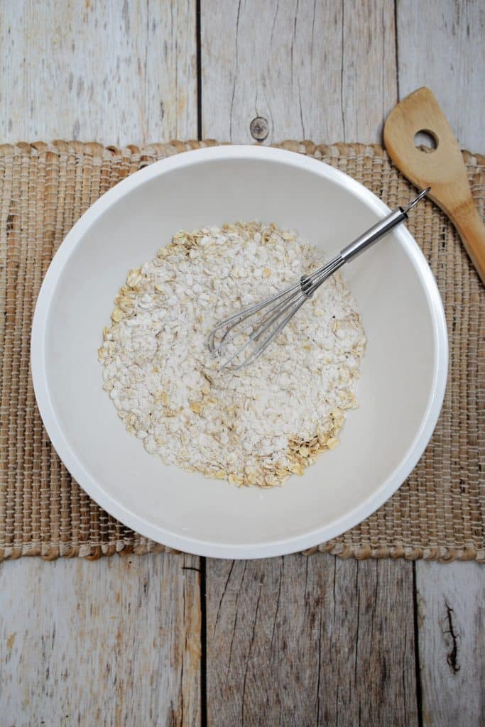 Baked Apple French Toast 9 flour and rolled oats in white mixing brown with silver wisk