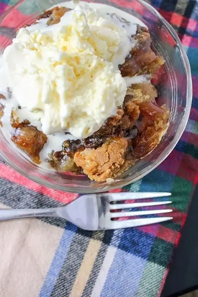 caramel apple dump cake in glass bowl with ice cream 