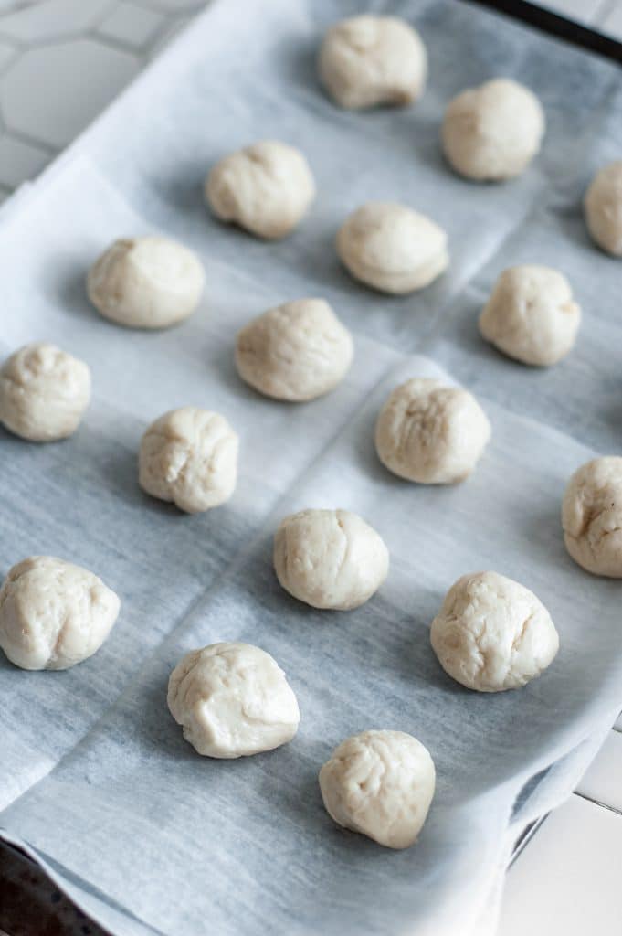 Cinnamon Sugar Donut Holes 17 rolled up canned biscuits on parchment paper