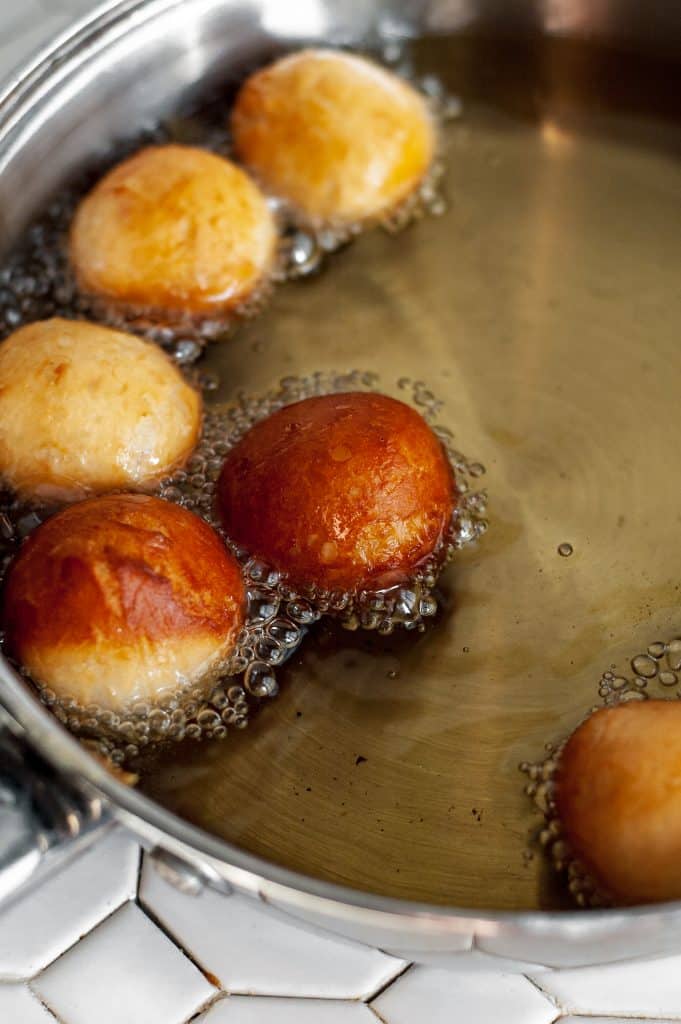 Cinnamon Sugar Donut Holes 20 rolled up canned biscuit frying in hot vegetable oil