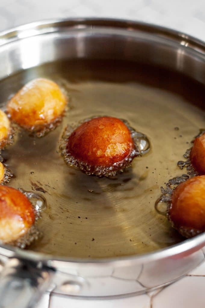 Cinnamon Sugar Donut Holes 21 rolled up canned biscuit cooking in hot vegetable oil