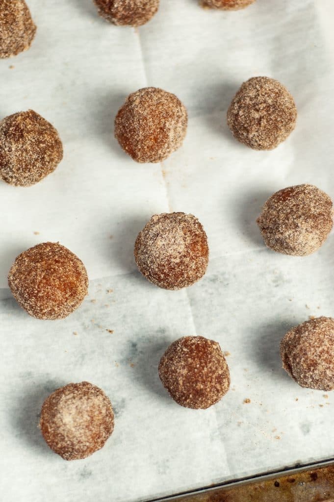 Cinnamon Sugar Donut Holes 33 cinnamon sugar donut holes on parchment paper