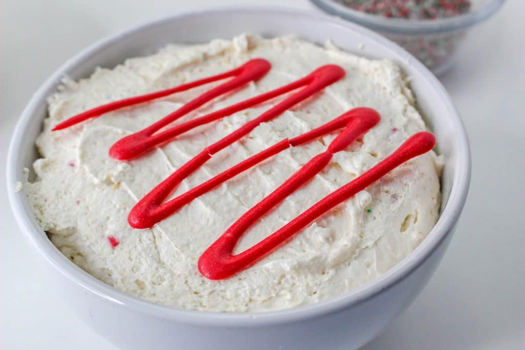 Little Debbie Christmas Tree Cake Dip (Easy No Bake Christmas Dessert) 12 red candy melt drizzle on top of christmas tree cake bowl