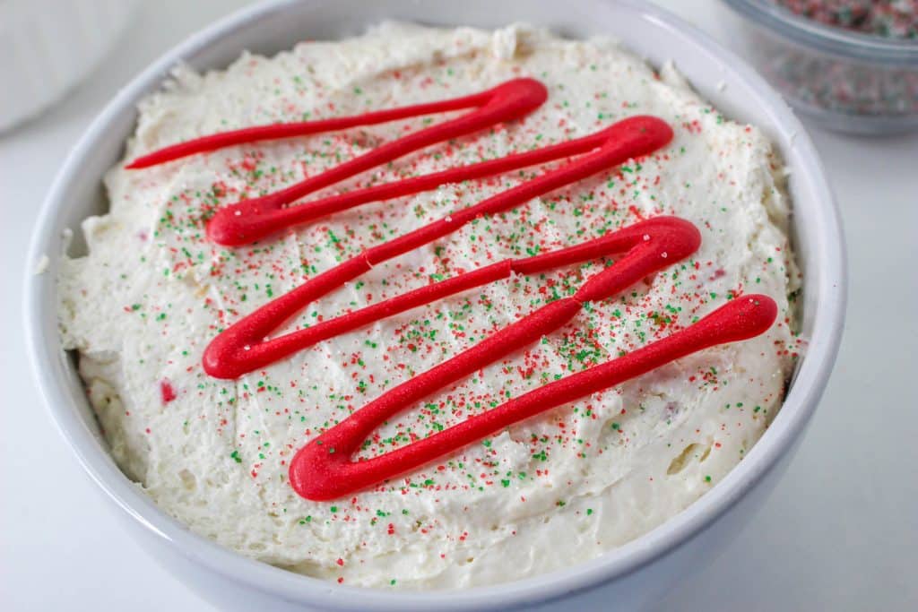 Little Debbie Christmas Tree Cake Dip (Easy No Bake Christmas Dessert) 13 bowl of Little Debbie Christmas tree cake dip with red drizzle on top