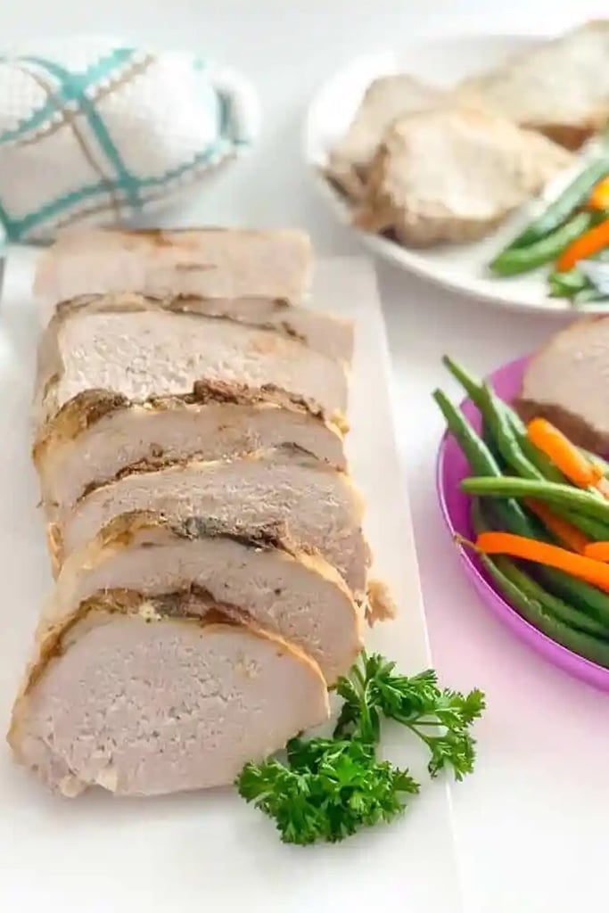 Slow Cooker Thanksgiving Recipes 11 slow cooker pork loin on white plate
