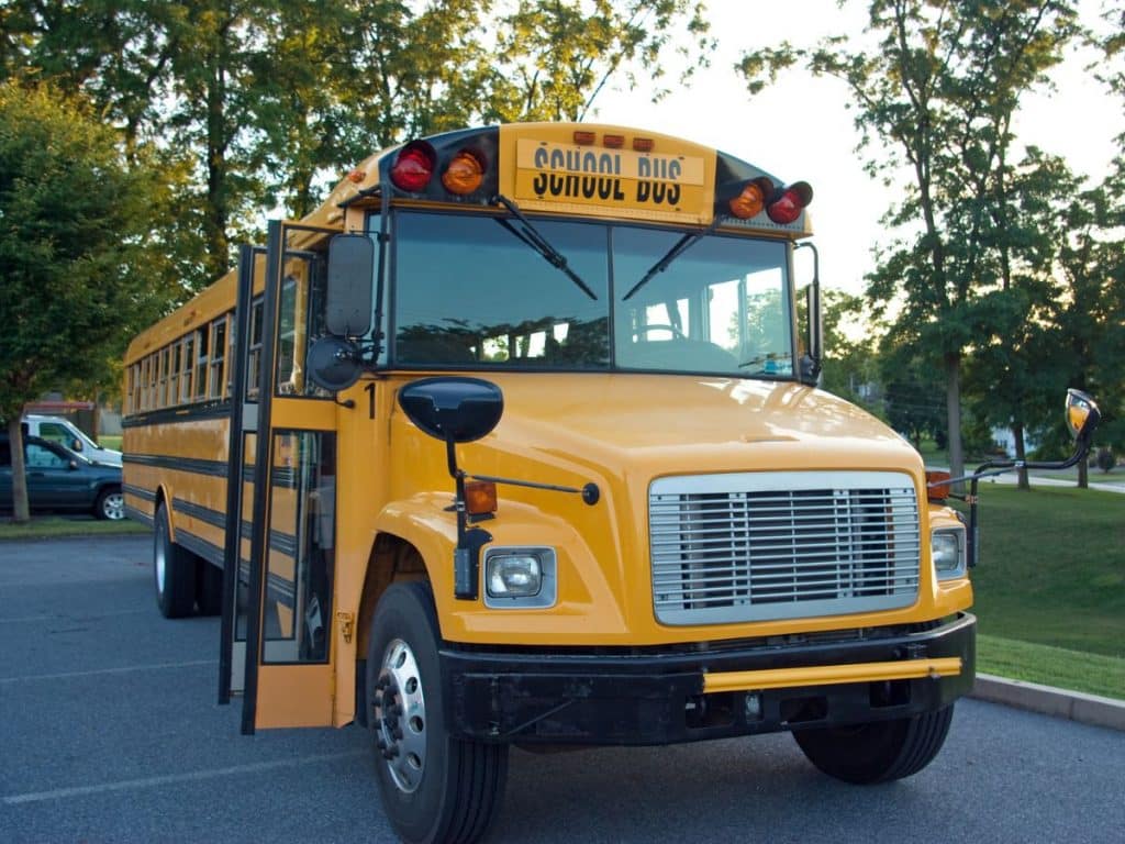 7 Christmas Gift Ideas for Bus Drivers That Will Make Them Feel Appreciated 3 yellow school bus in parking lot with doors open