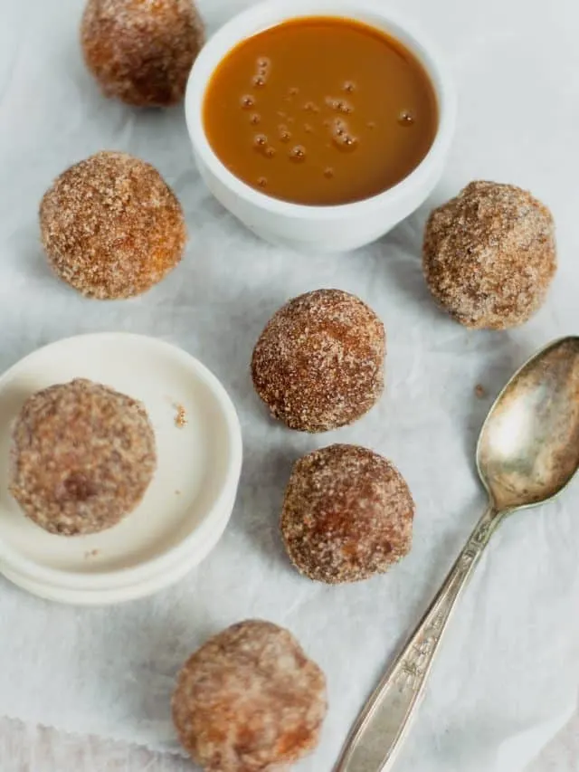 Old Fashioned Donuts 12 cinnamon sugar donut holes on parchment paper with spoon