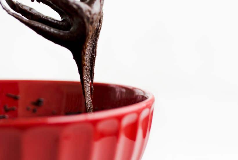 Easy Rolo Brownie Bites 8 pouring chocolate rolo brownie batter into red bowl