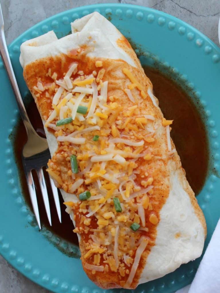 Taco Bell Enchrito Copycat Recipe 9 Smothered Taco Bell copycat enchirito on an aqua plate with a fork