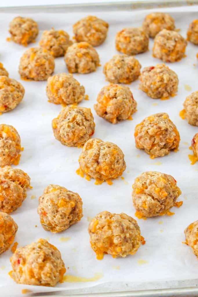 3 Ingredient Sausage Cheese Balls with Pimento Cheese 20 raw Pimento Cheese Sausage Balls on parchment paper on baking tray