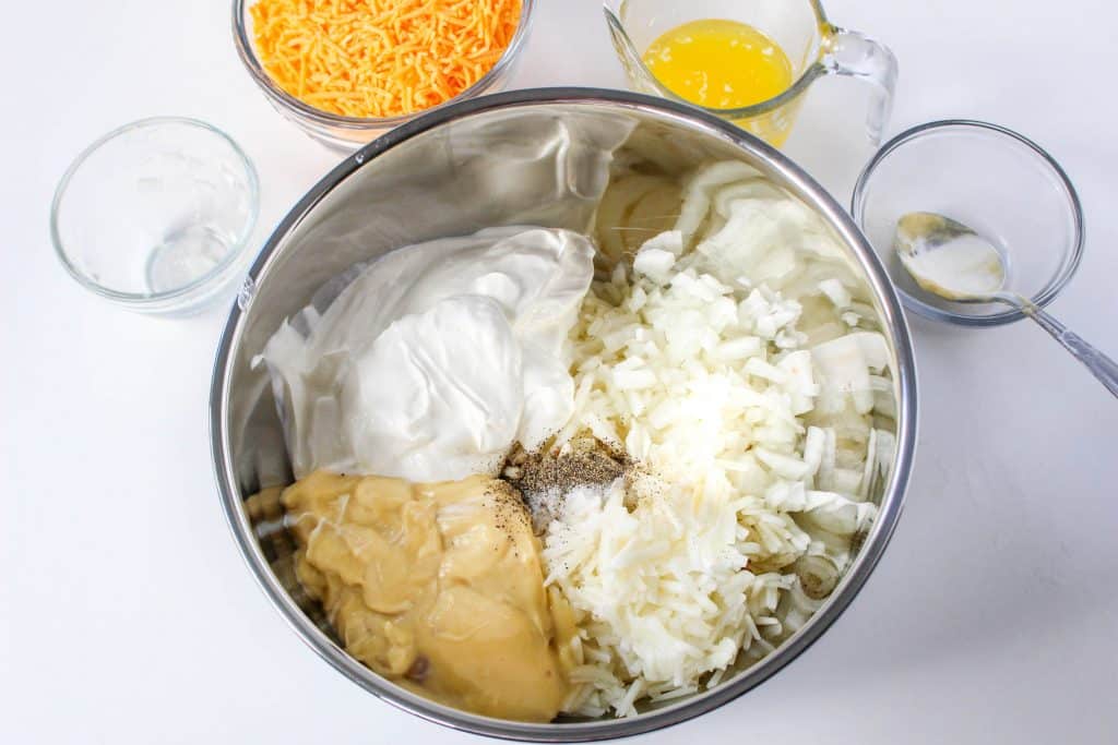 Slow Cooker Cracker Barrel Cheesy Hash Brown Casserole 12 Slow Cooker Cracker Barrel Cheesy Hash Brown Casserole ingredients in a stainless steel mixing bowl