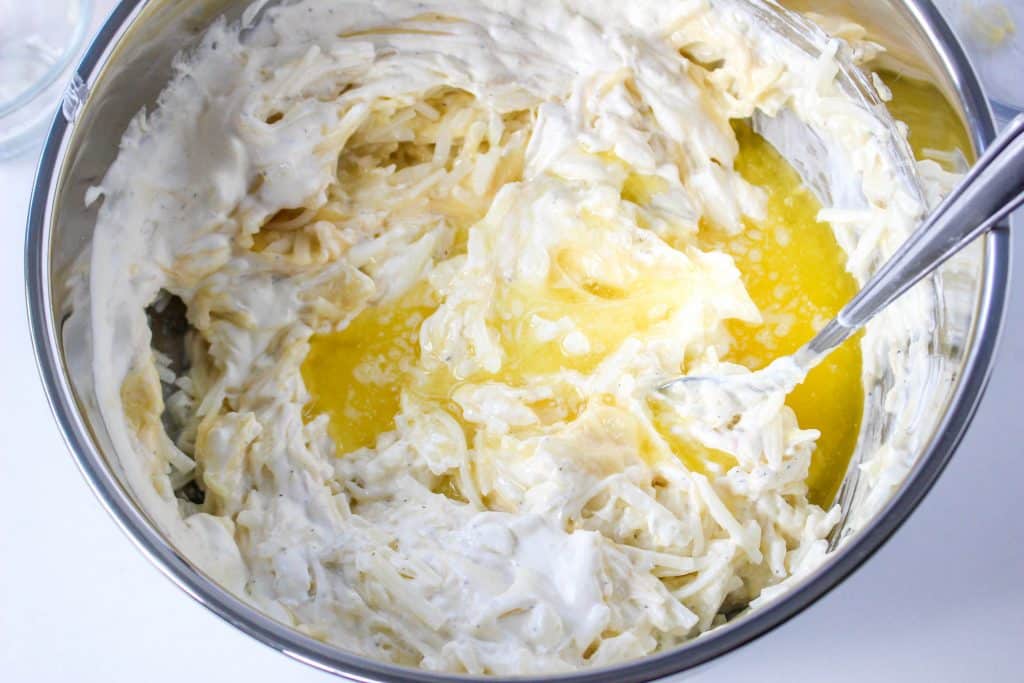 Slow Cooker Cracker Barrel Cheesy Hash Brown Casserole 16 Slow Cooker Cracker Barrel Cheesy Hash Brown Casserole ingredients in bowl with butter on top