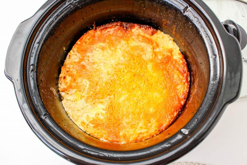 Slow Cooker Cracker Barrel Cheesy Hash Brown Casserole 19 Slow Cooker Cracker Barrel Cheesy Hash Brown Casserole in crockpot with melted cheese on top