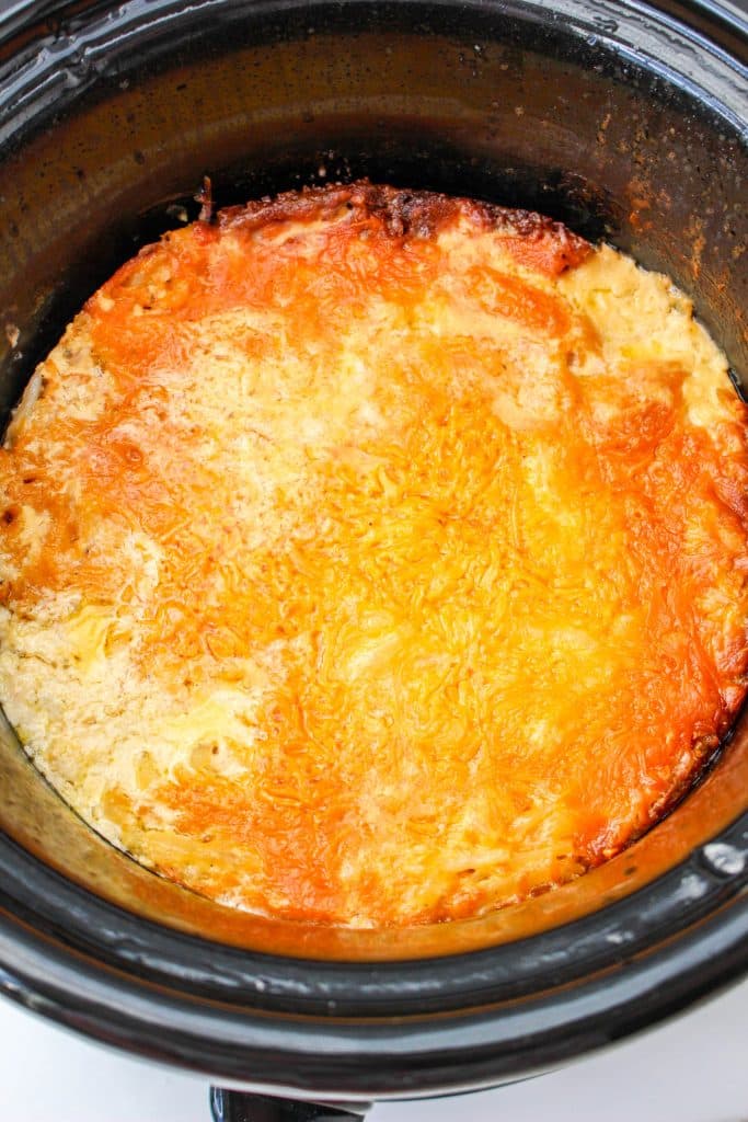 Slow Cooker Cracker Barrel Cheesy Hash Brown Casserole 18 Slow Cooker Cracker Barrel Cheesy Hash Brown Casserole in crockpot with melted cheese on top