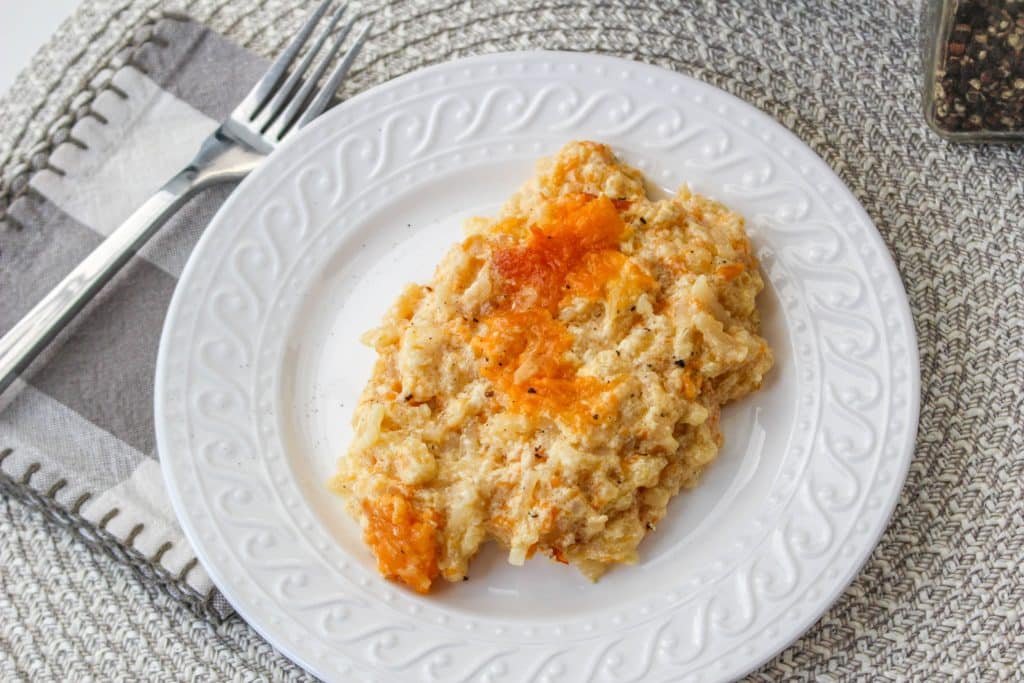 Slow Cooker Cracker Barrel Cheesy Hash Brown Casserole 5 overhead view of cooked hash brown casserole in slow cooker on white plate