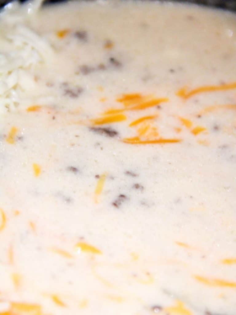 Sausage Potato Soup in Crockpot 9 Close up of sausage potato soup with shredded cheese.