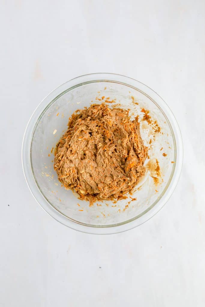 Carrot Cake Cookies 26 overhead view of clear bowl with carrot cake cookie sandwich ingredients mixed.
