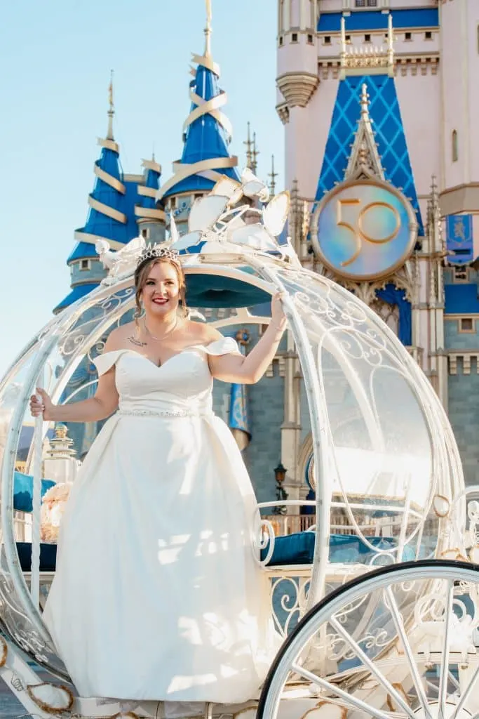 Bride in Cinderella's Coach in Front of Disney World castle in Magic kingdom for Disney World Vow Renewal 