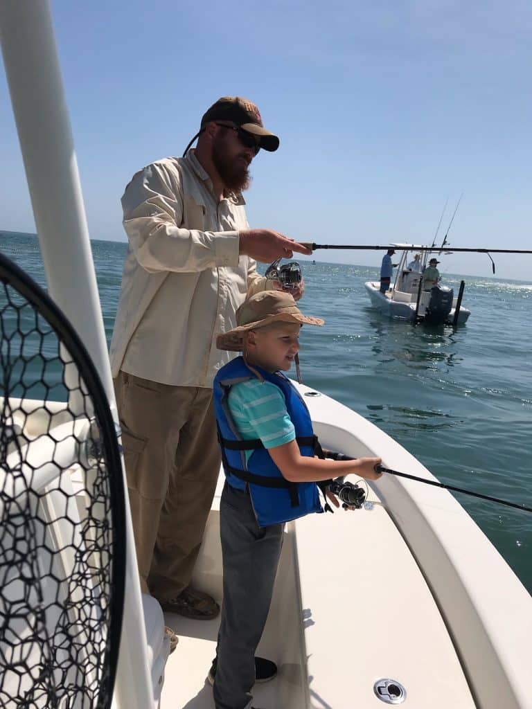 10 Free Things to do in St. Augustine With Kids (2025) 4 Child and Dad fishing from boat in St Augustine