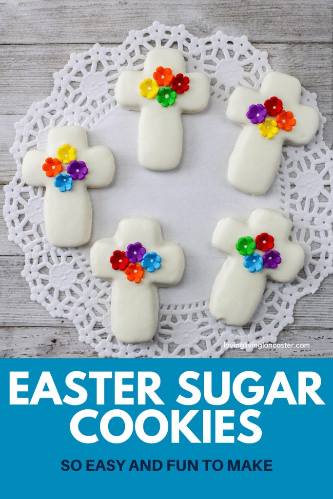 Easter sugar cookies that are decorated with flowers laying on a doily