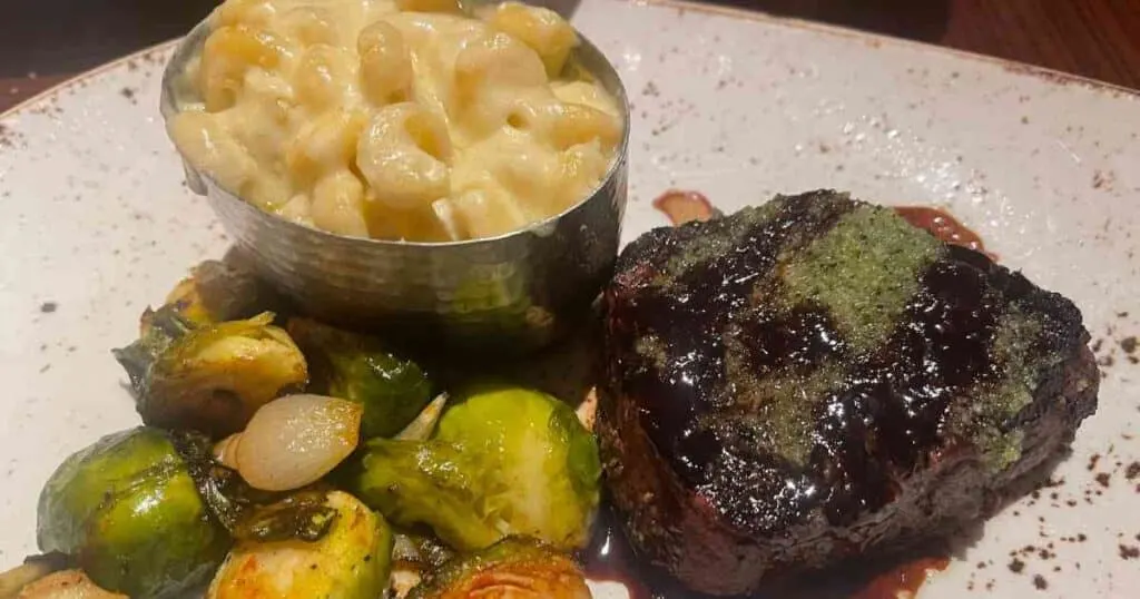 Filet mignon, brussels sprouts, macaroni and cheese on plate at Jiko at Animal Kingdom Lodge Jambo House 