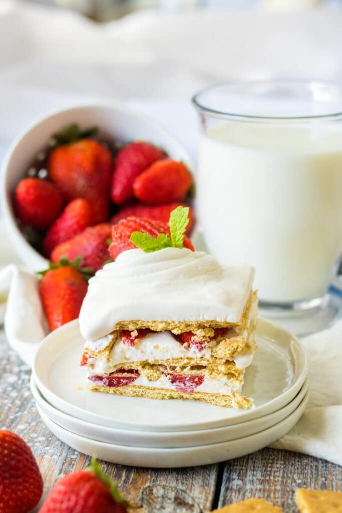 strawberry ice box cake on white place with strawberries in background